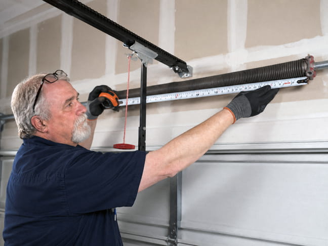 Larry measuring a torsion spring for replacement on a garage door in Concord CA
